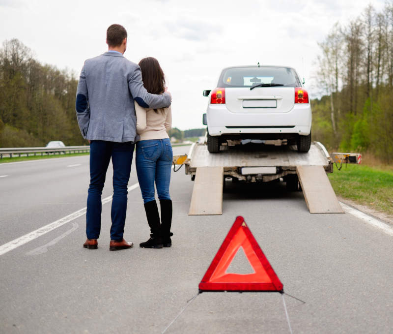 car being responsibly towed away by a tow truck